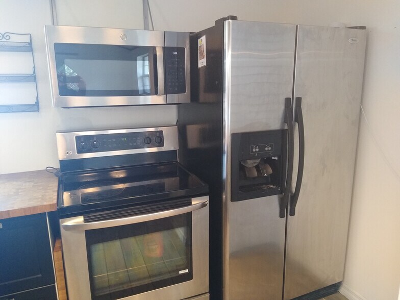 Stove microwave and fridge. - 9328 N Ashley St