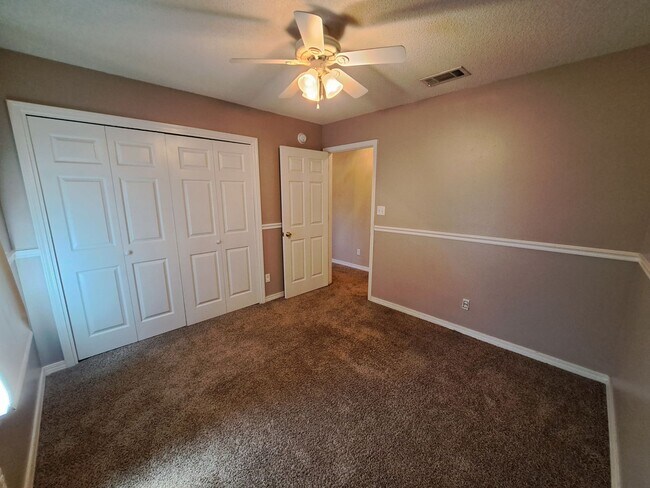 Building Photo - 4BR/3BA with privacy fenced backyard