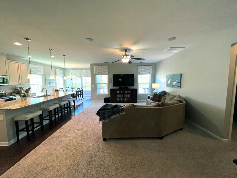 The open floor plan features a spacious great room into the large kitchen and dining room. - 7736 Tranquil Trl