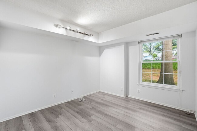 Building Photo - This expansive ground level residence is set within a serene, gated garden community surrounded b...