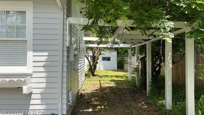 Building Photo - This 3-bedroom 1-bathroom house has a large front yard and a mostly fenced backyard.