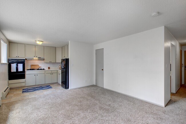 Experience the charm of this open living area designed for modern living. - Harmony Apartments