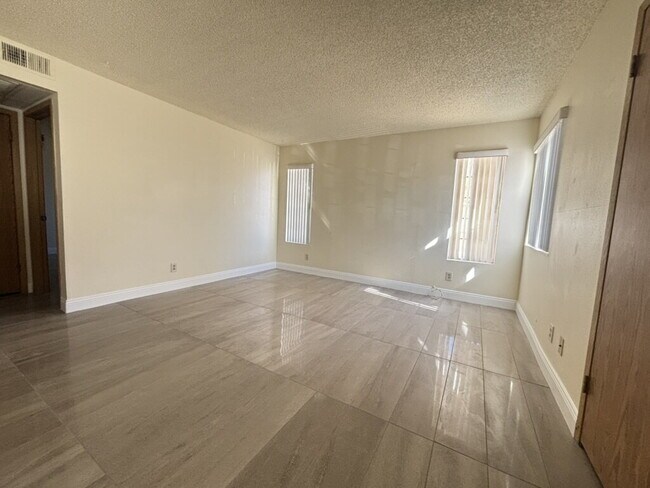 Building Photo - Downstairs 2BR/1BA—recently updated with new flooring, new countertops, and clean, neutral finishes.