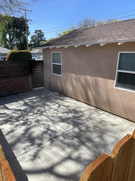 Private, gated cement patio area with space for outdoor seating and added privacy; backyard access - 327 Aliso St