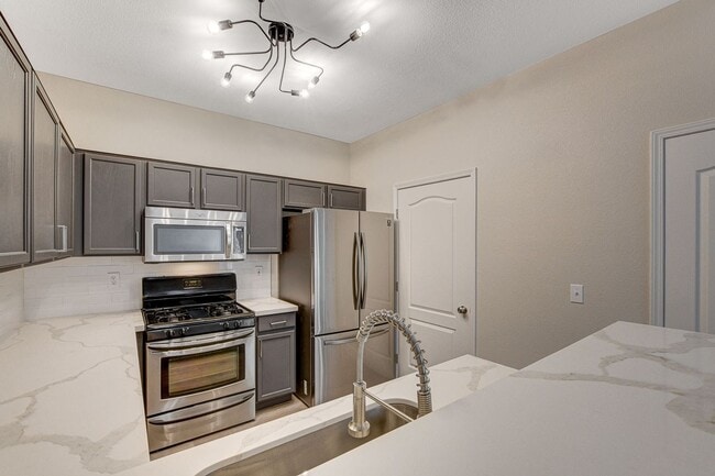 Building Photo - Upgraded First-Floor Condo in a Gated Summ...