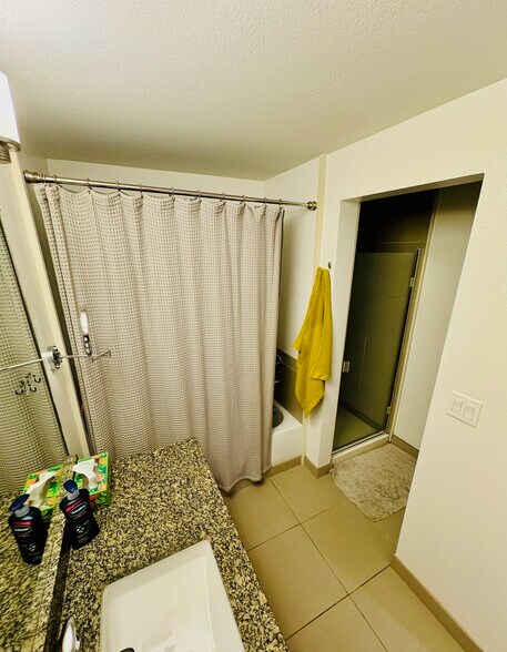 Convenient side-mounted shower adjacent to the bathtub for easy access and versatile use - 2145 Dexter Ave N