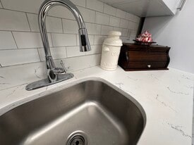 Fresh white kitchen with a brand-new stove and modern appliances. - 353 High St