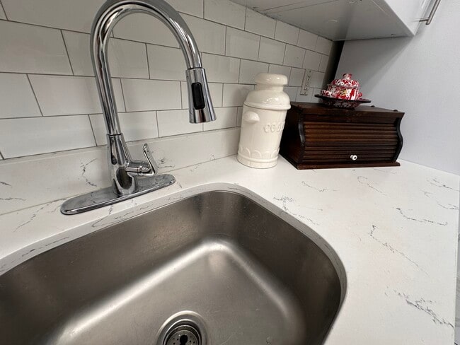 Fresh white kitchen with a brand-new stove and modern appliances. - 353 High St
