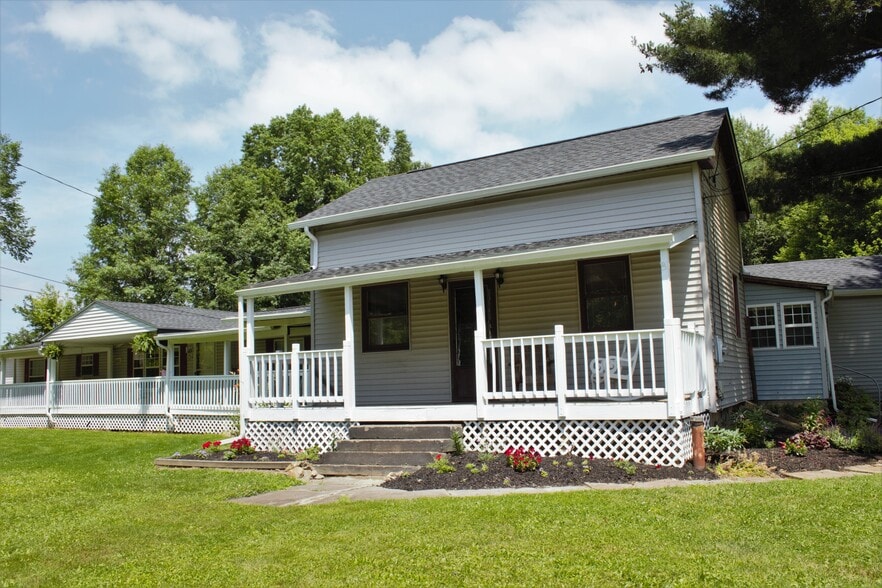 Front of home, (south side) has private front porch and entrance. Perennial flower beds all around home. - 9331C Tallmadge Road
