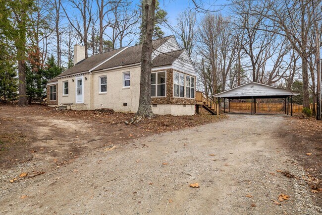 Building Photo - Brick home, Two Story, Hardwoods, DR, 2 Sun Rooms, FP, Carport!.