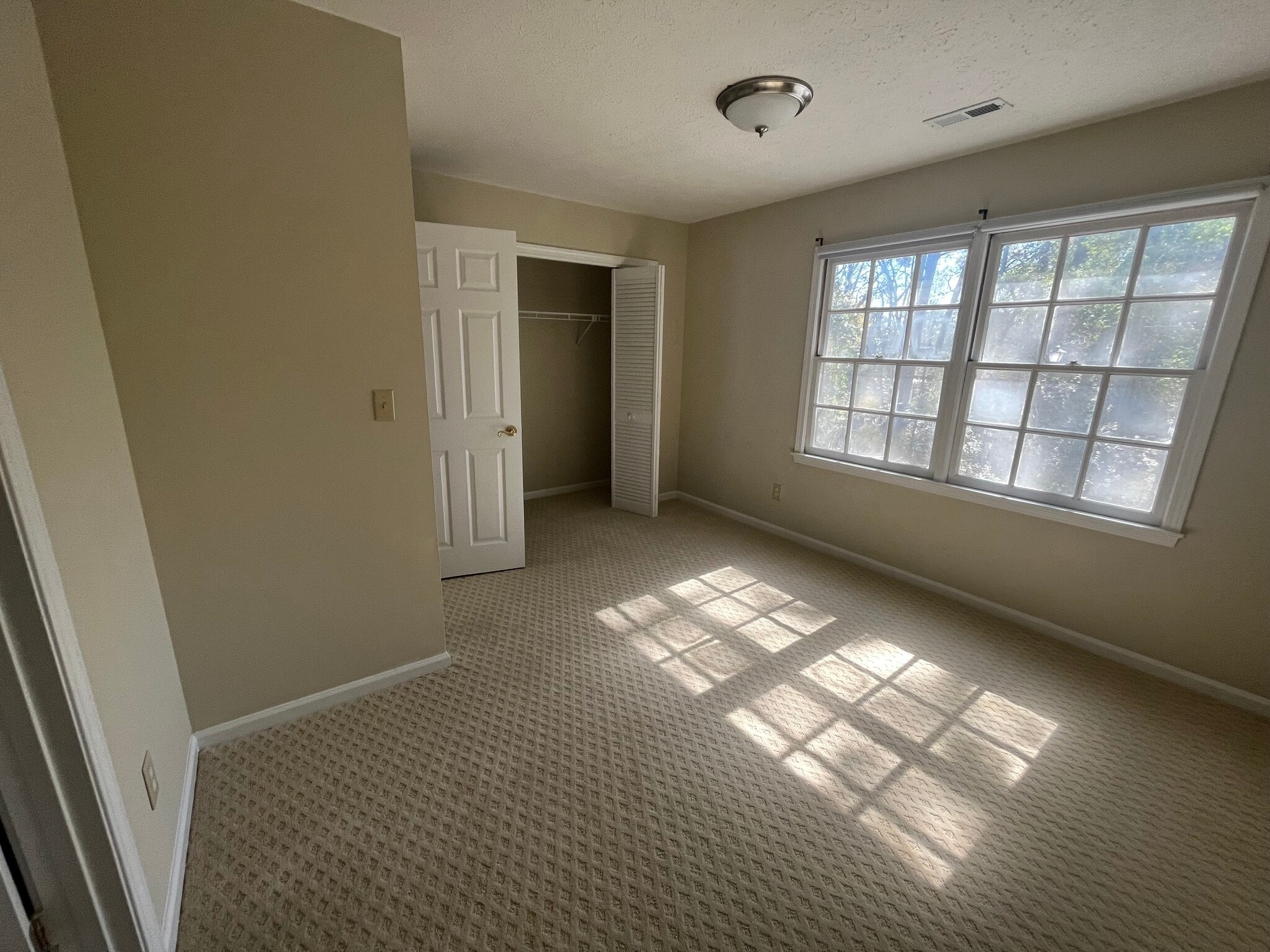 Second bedroom with great natural light and large closet space connected to the half bath - 830 44th Ave N