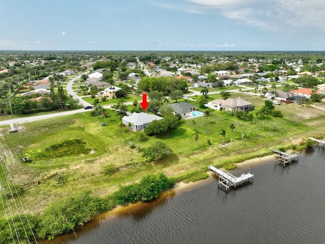 Building Photo - A BOATER'S PARADISE WITH THIS STUNNING 3 BEDROOM, 2 BATH WATERFRONT POOL HOME W/DOCK & BOAT LIFT ...