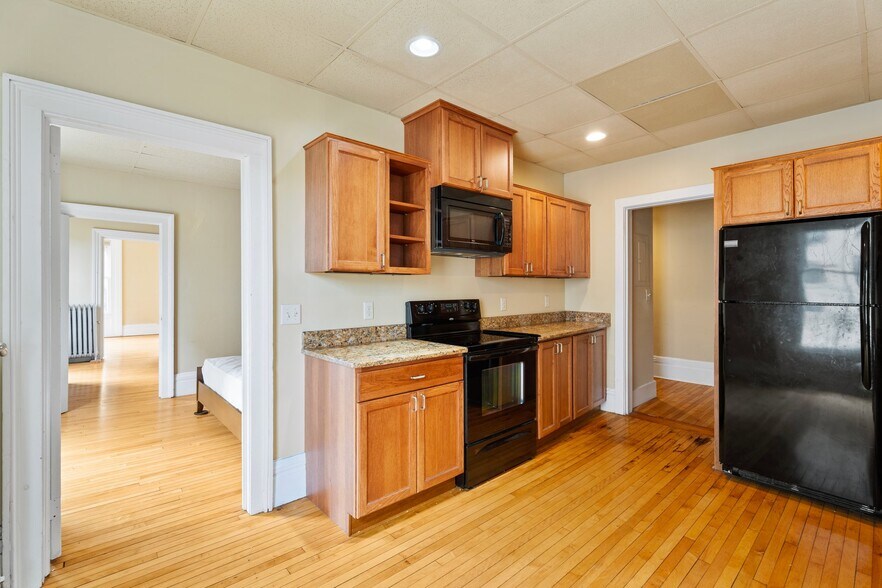 Renovated kitchen with granite counter tops and cherry wood cabinets - 102 N Tioga St