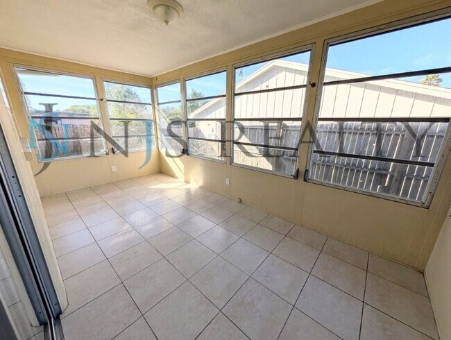 Building Photo - JUST REDUCED!!!  3/2/2 1500 Sq. Ft. with fenced yard, tile floors, HUGE living room and a corner ...