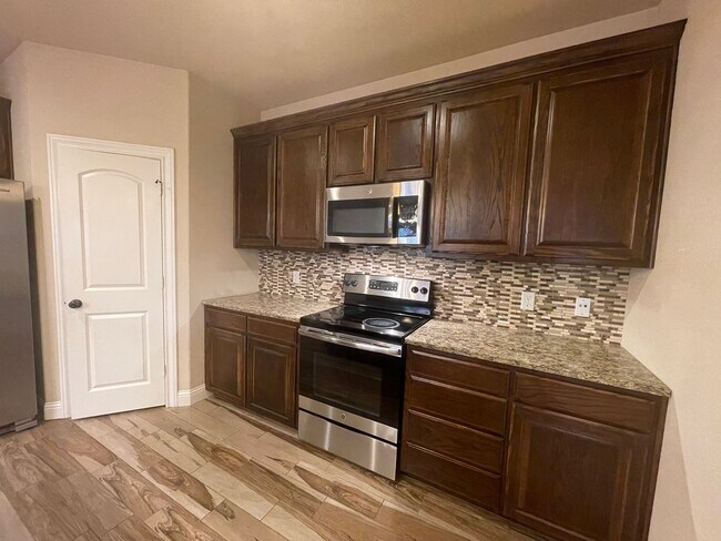 Building Photo - Beautiful Benbrook 3B/2.5B Townhome ((Stainless Steel Appliance Package)) Dazzling wood-like tile...