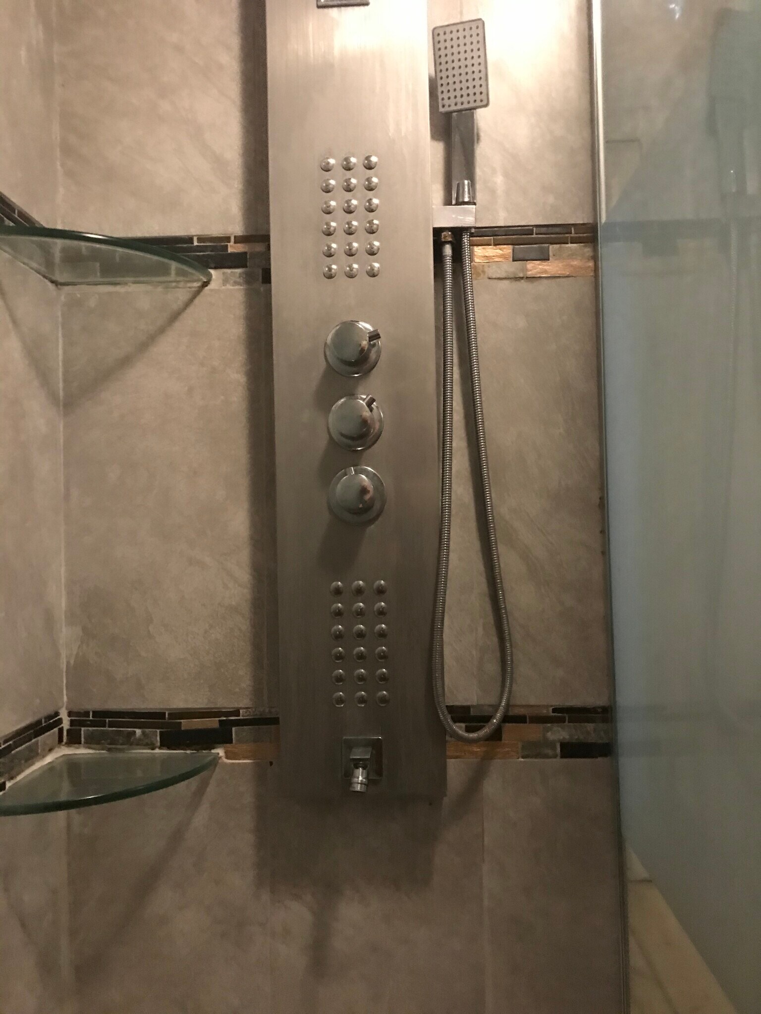Bathroom with glass and custom tile and glass shower with multi-spray shower tower. - 3000 Clarcona Road