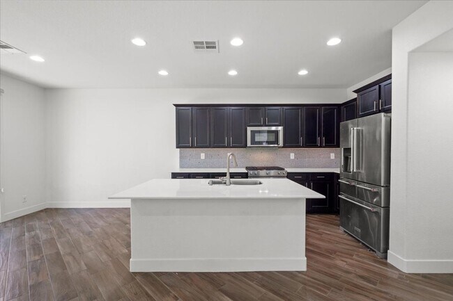 Building Photo - Modern Gated 3 Bedroom Retreat with Loft & Entertainer’s Backyard