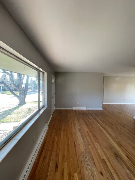Living room with big window to front yard - 7991 E Hampden Cir
