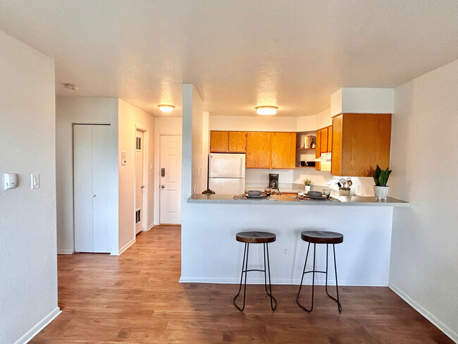 Experience modern living with this stylish apartment featuring a cozy kitchen setup. - One Park View