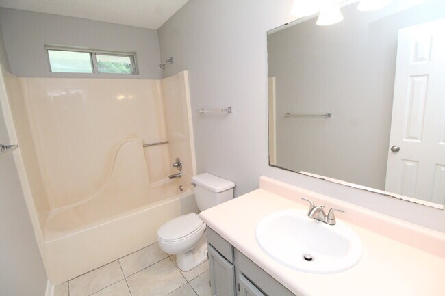 Building Photo - West Pensacola Brick Home with Vaulted Ceilings, Split Floor Plan, Open Living Design & Easy Acce...