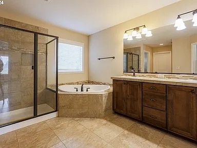 Walk-in Shower, Bathtub, Double Vanities in Primary Bathroom - 6128 NW Trowbridge Dr
