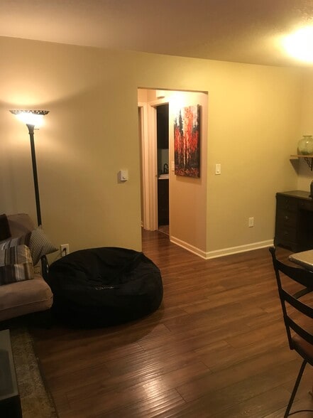 Middle section of open kitchen/living room, hallway to bedrooms & desk nook on right - 1209 W Plum St
