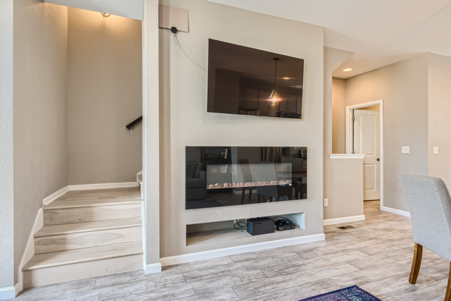 Second floor family room electric fireplace with hidden cable system for mounted television - 4280 E Warren Ave