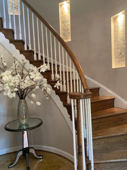 Entry with spiral stairs throughout and built in stone accents. - 2367 S Queen St