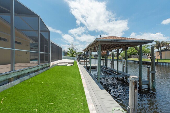 Building Photo - Live the ultimate Space Coast waterfront lifestyle at this stunning beachside canal home in Satel...