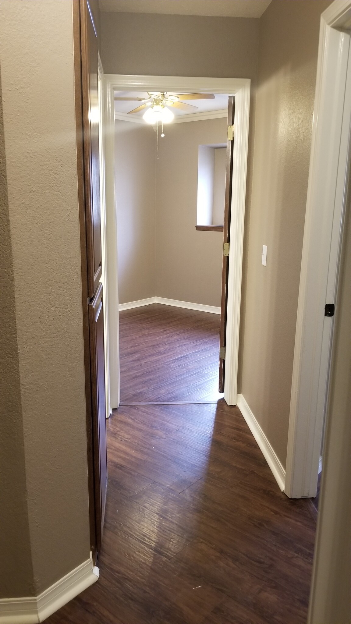 Hallway to 3rd bedroom, storage and restroom on the left - 10809 E 100th St N