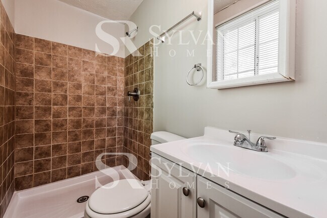 Building Photo - The living is easy in this 4 bedroom, 2 ba...