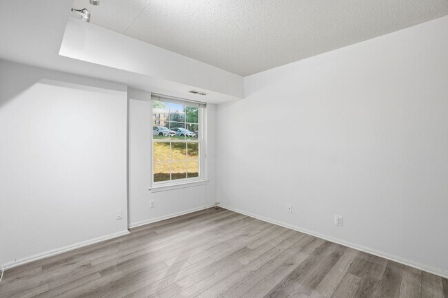 Building Photo - This expansive ground level residence is set within a serene, gated garden community surrounded b...