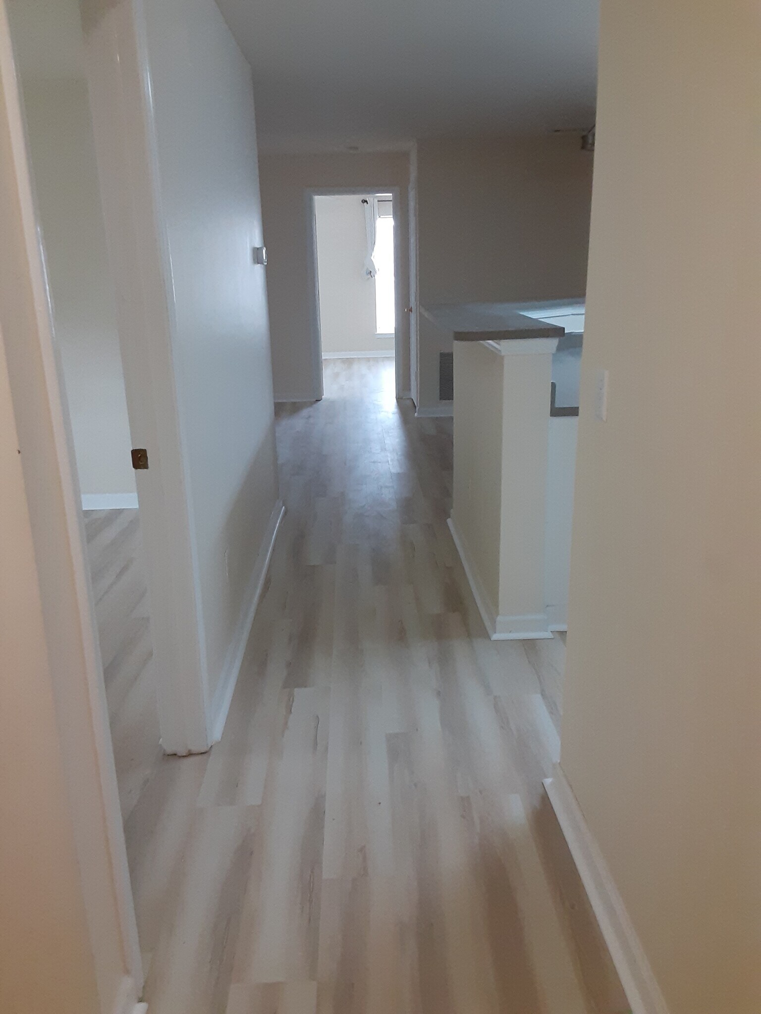 Entrance hallway leads to second bedroom and bathroom on left, kitchen on right, LR/DR at end - 100 Kensington Blvd