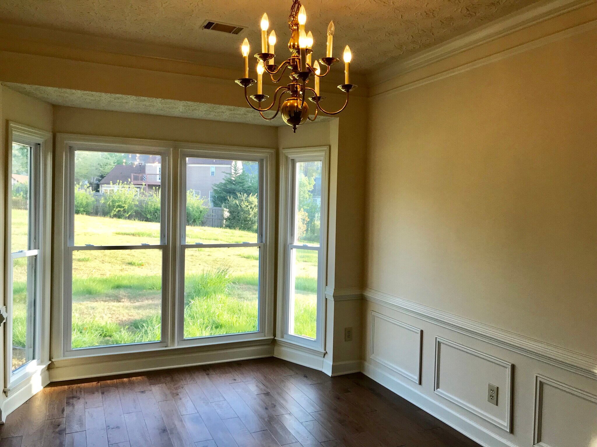 Newer engineering floor in open living room facing back yard with a lot natural light. - 2794 Craig Ct