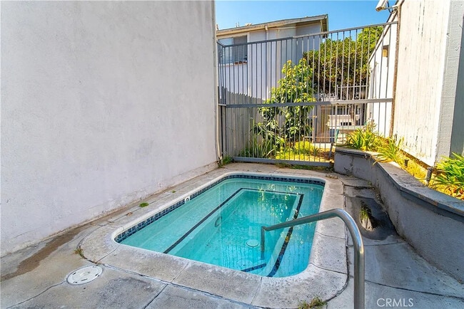 Building Photo - Bright 2-Bed Condo with Central Air, Pool Access & Carport in Anaheim