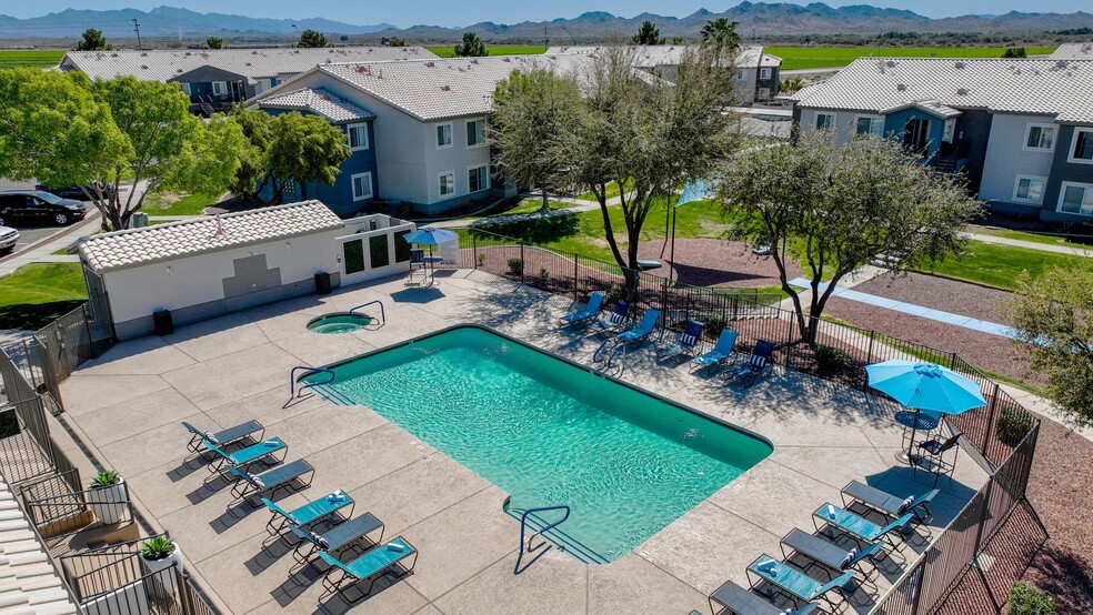 Lay back, soak up the sun on our expansive poolside sundeck - your own backyard oasis of relaxation. - Riverwood Apartments