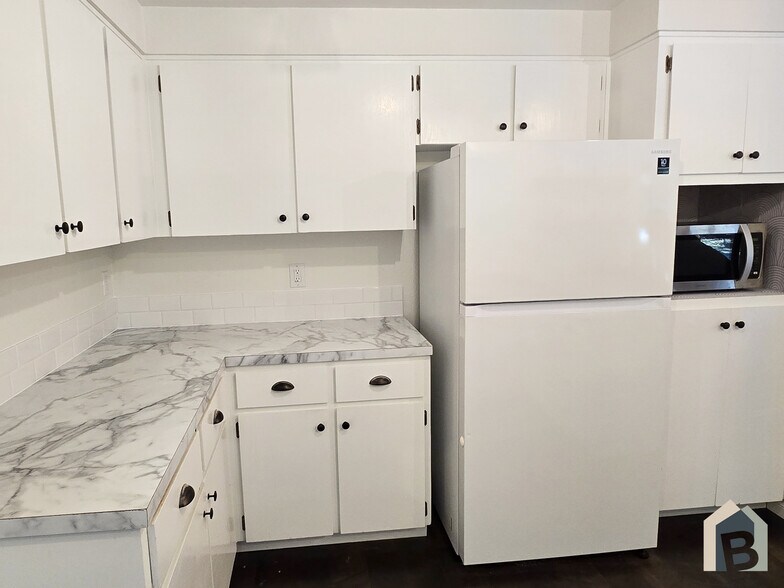 Brand new kitchen countertops, stove, stainless sink, faucet, tile, and microwave - 20981 Port Gamble Rd NE