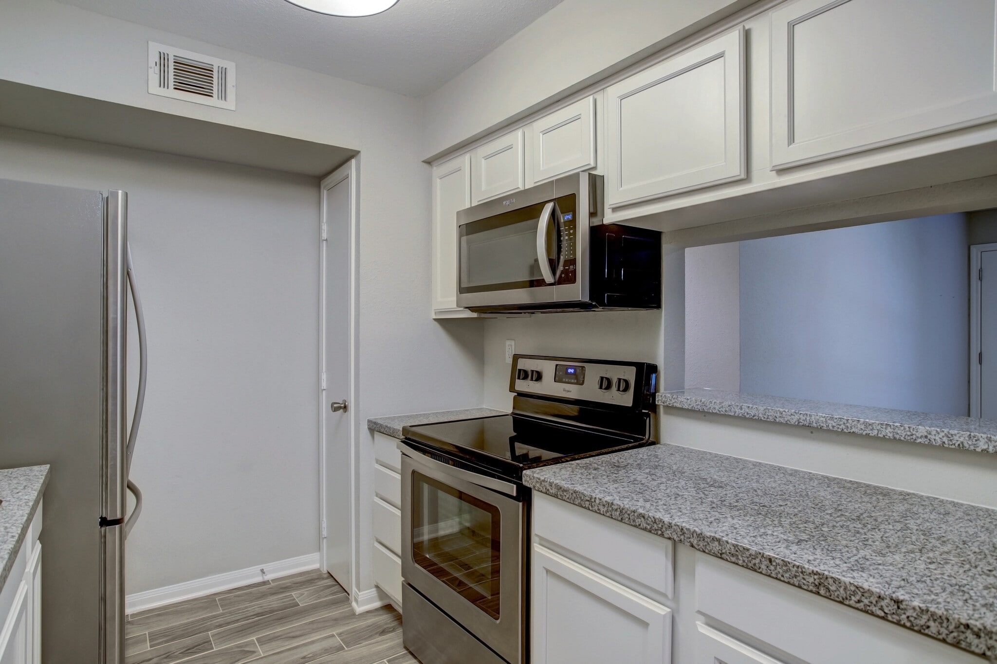 Kitchen w/stainless steel appliances. - 1880 White Oak Dr. Apt 119