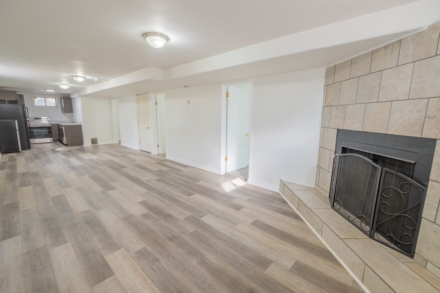 Large open concept living room/kitchen area. Fireplace is not functional. - 1415 Concord St