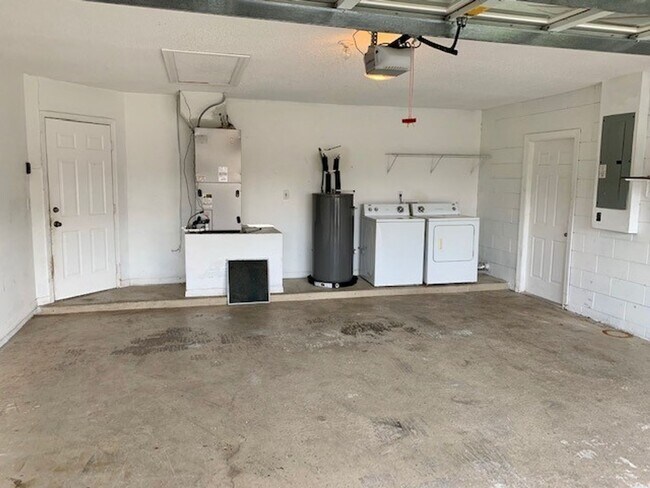 Building Photo - Available NOW! NEW FLOORS AND PAINT! Lovely 3/2 in Poinciana! HUGE fenced yard and NO CARPET!