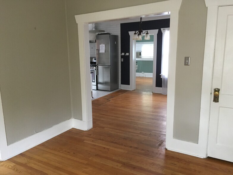 In the living room looking back towards the dining, kitchen and bedroom. - 945 Washington St