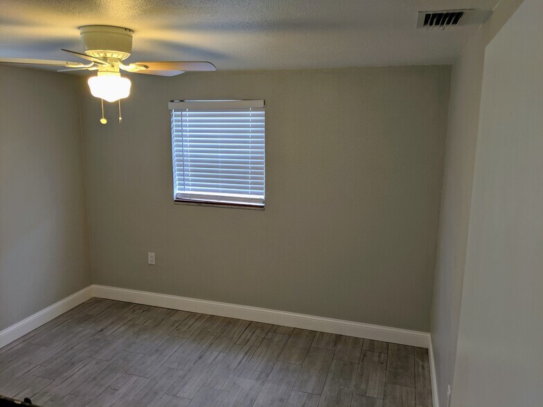 Spacious bedroom with ceiling fan and window - 1147 Jennings Dr