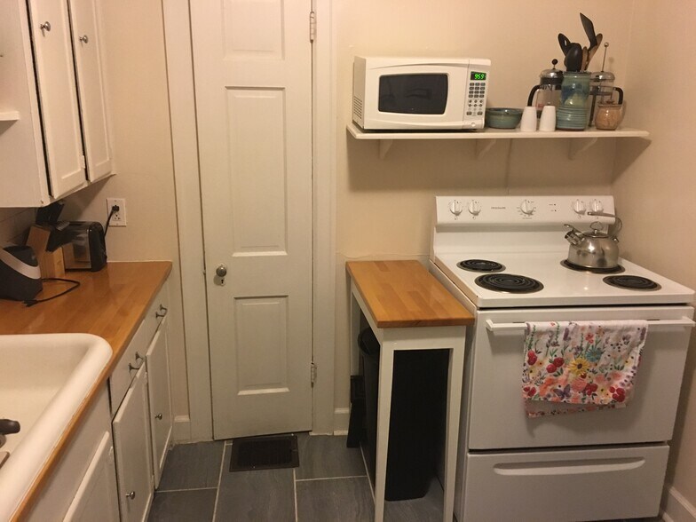 Kitchen (as seen on the other side of the duplex, but remodeled kitchen is a similar size and will have same flooring and countertops.) - 128 Barberry Lane