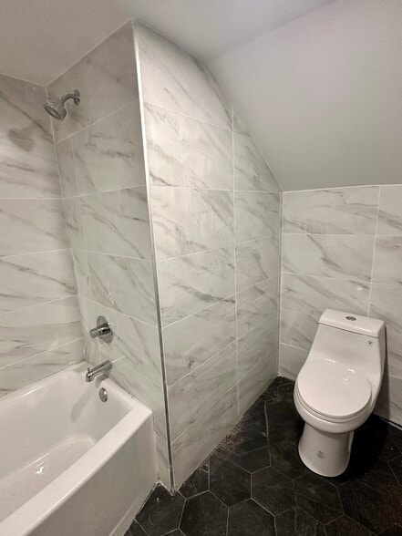 Primary bathroom with a stylish full shower and updated finishes. - 328 High St