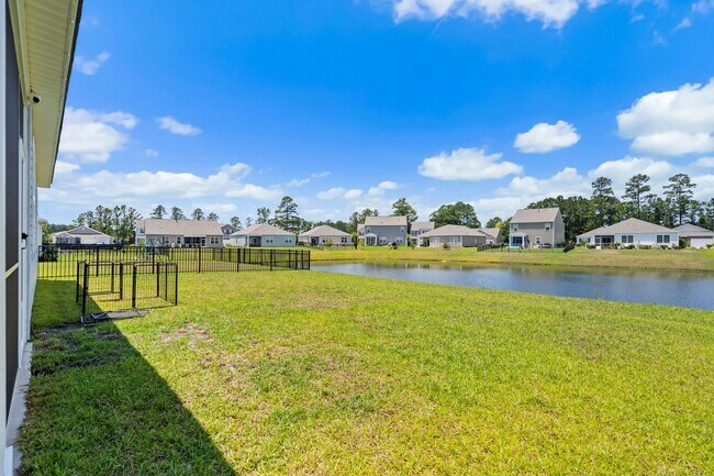 Building Photo - Modern 4BR Home with Screened Porch & Pond Views | Sun Colony, Longs SC