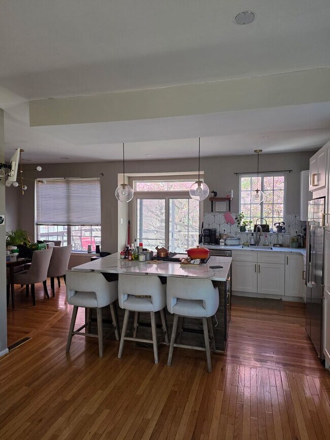 Building Photo - Stunning 3–4 Bedroom Townhome in Private Community | Garage + EV Charger | Deck with Tree Views