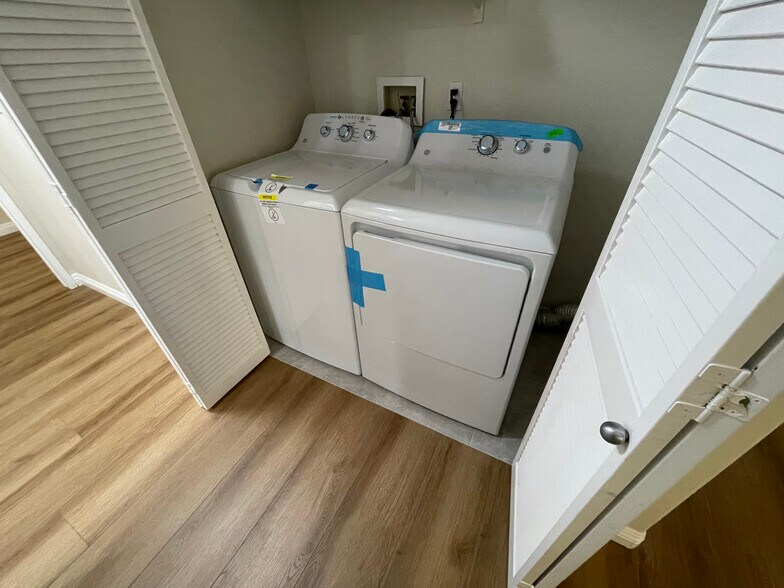 new washer and dryer in unit hallway - 2960 Champion Way