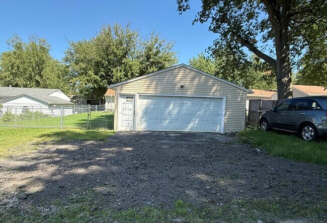 Detached garage and additional parking and fenced backayard. - 1444 Dodge St