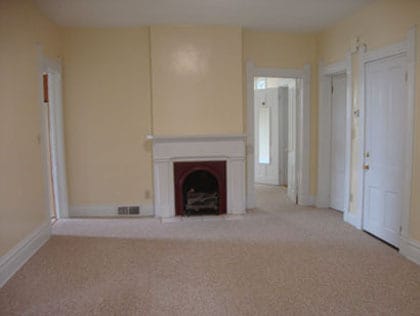Living room with vent-free gas log fireplace, as seen from the bay windows. - 512 S Center St