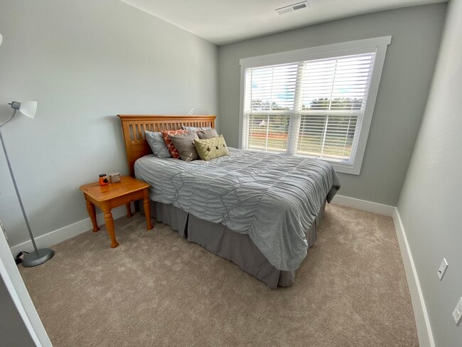 Bedroom 2 with tons of natural light and double door storage closet - 140 Sunburst Villa Dr
